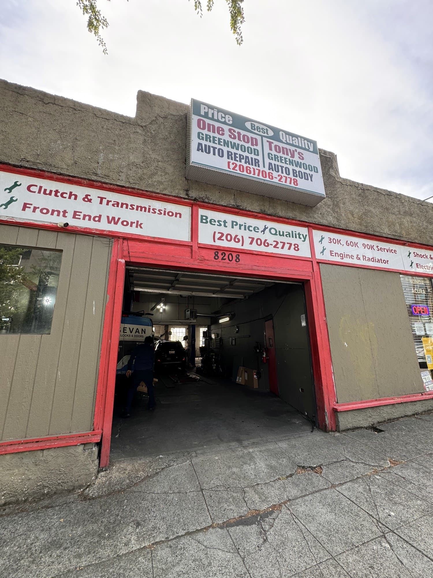 Tony's Greenwood Auto Body lit sign and service banners at 8208 Greenwood Ave